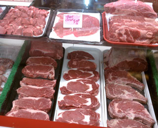 Meat Counter showing cutlets, steaks and sausages